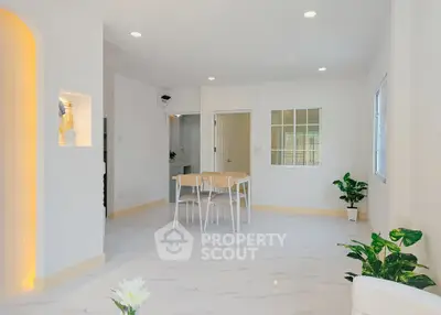 Spacious modern living room with elegant dining area and bright natural lighting.
