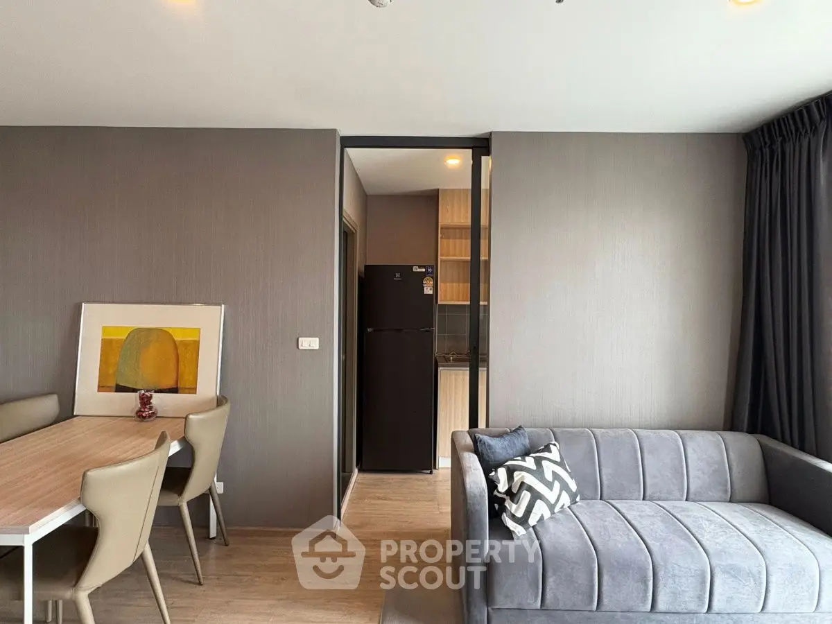 Modern living room with stylish furniture and open kitchen layout