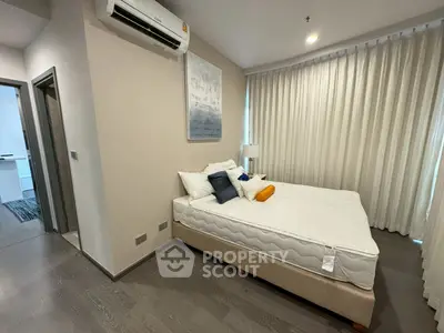 Modern bedroom with cozy bed and air conditioning in stylish apartment.