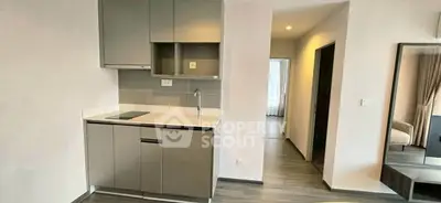 Modern compact kitchen with sleek cabinetry and integrated appliances