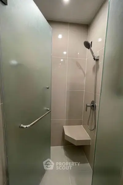 Modern bathroom with sleek shower design and built-in seat