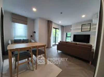 Modern living room with stylish furniture and large windows offering natural light.
