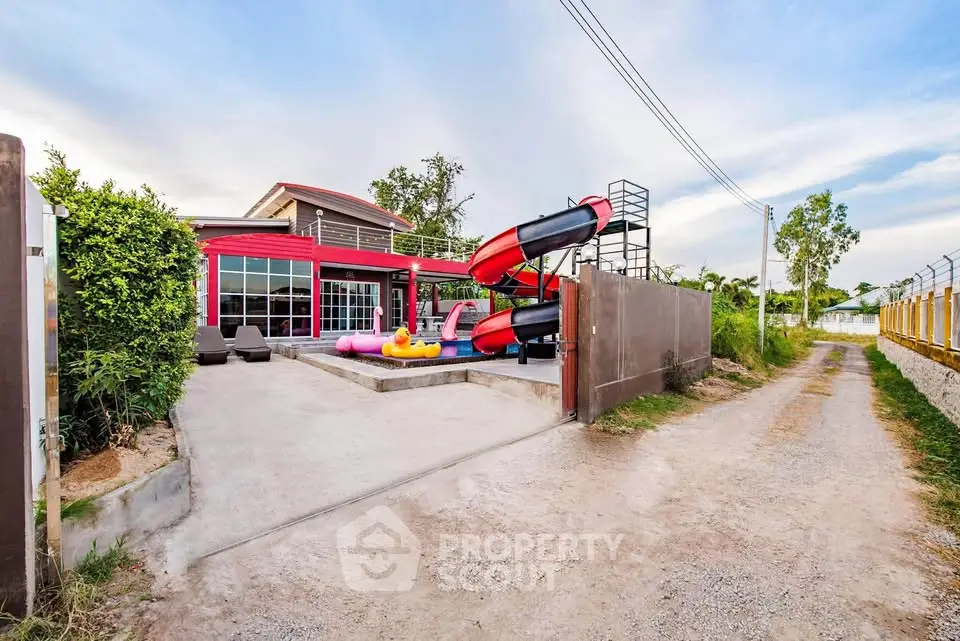 Stunning modern home with vibrant exterior and private water slide