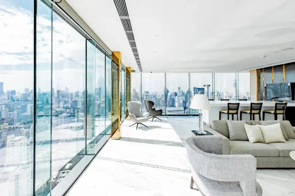 Luxurious modern living room with panoramic city views and elegant furnishings.