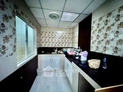 Charming kitchen with floral tiles and modern appliances, perfect for culinary enthusiasts.
