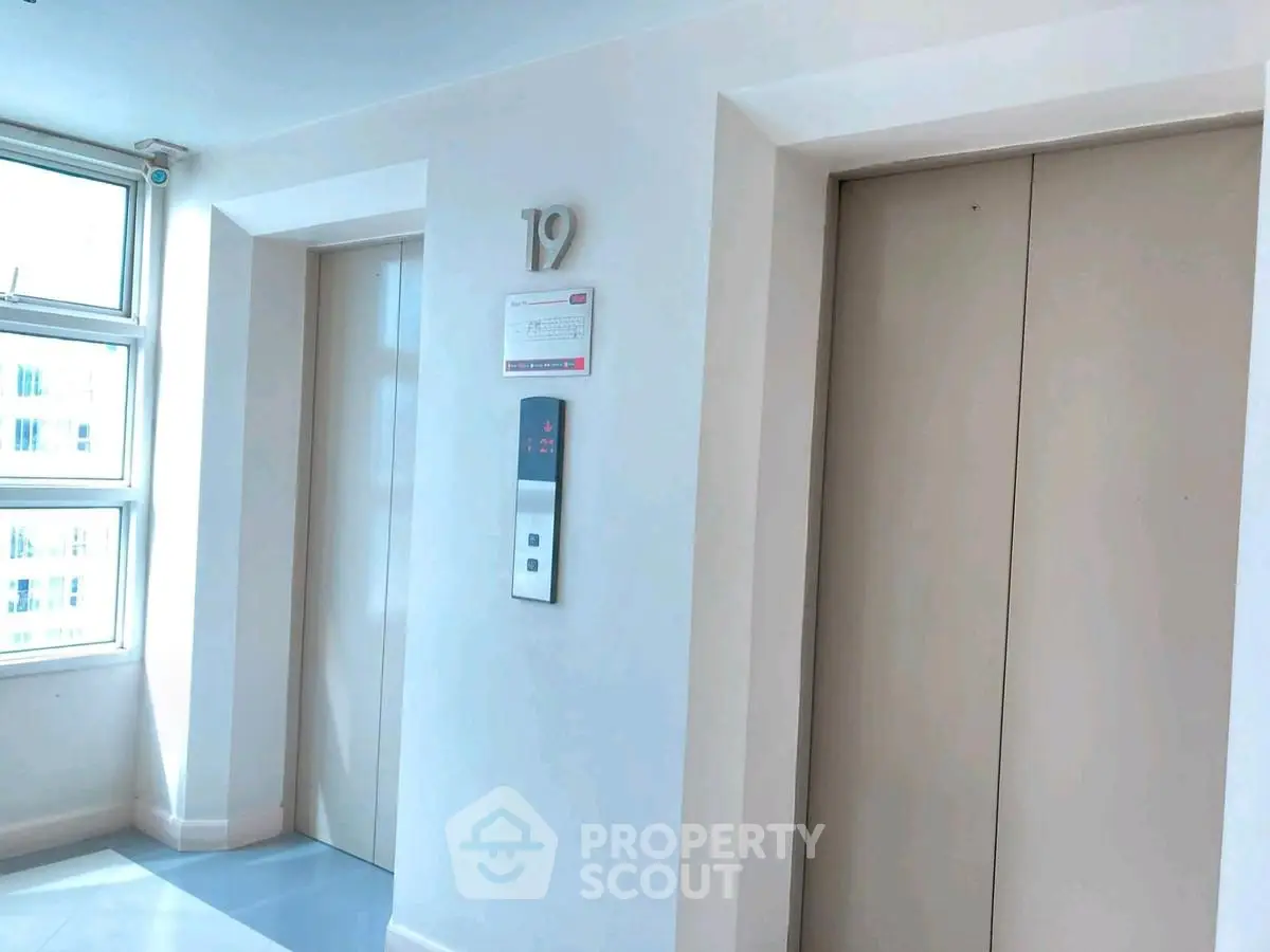 Modern building elevator lobby with natural light and sleek design