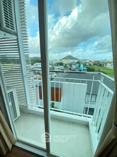 Charming balcony with stunning cityscape view from a modern apartment, perfect for relaxation and enjoying the skyline.