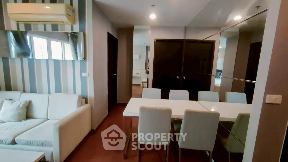 Modern living room with stylish dining area and air conditioning in a contemporary apartment.