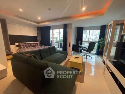 Spacious modern living room with green sofa and city view balcony