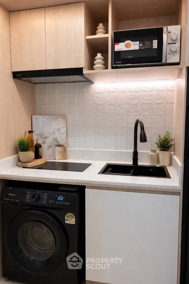 Modern compact kitchen with sleek appliances and stylish decor