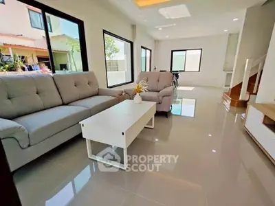 Spacious modern living room with elegant furniture and large windows