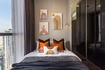 Stylish bedroom with modern decor and city view in high-rise apartment