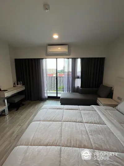 Modern bedroom with balcony view and stylish decor in urban apartment