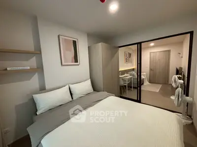 Modern bedroom with stylish decor and cozy ambiance in a contemporary apartment.