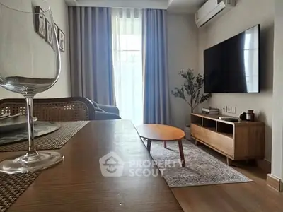 Modern living room with stylish furniture and large TV, perfect for relaxation and entertainment.