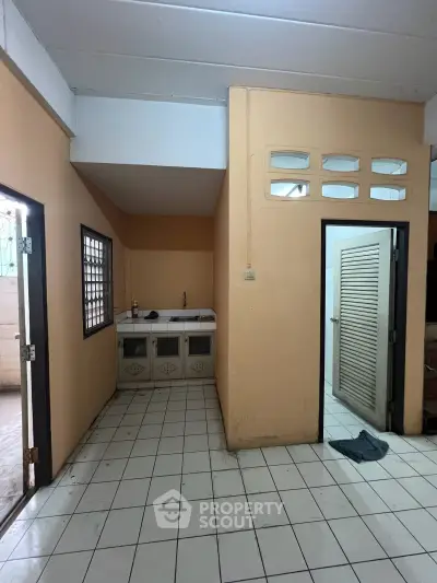 Cozy kitchen area with tiled flooring and open layout, perfect for small apartments.