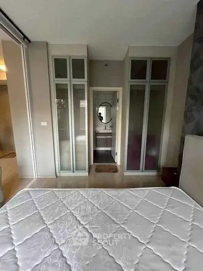 Modern bedroom with ensuite bathroom and stylish glass doors