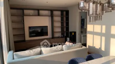 Spacious living room with modern decor and large windows for natural light.