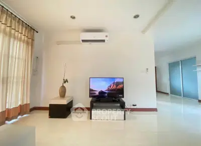 Spacious living room with modern decor and natural light