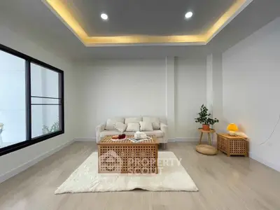 Modern living room with cozy sofa, stylish coffee table, and ambient lighting for a serene atmosphere.