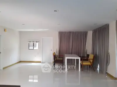 Spacious minimalist living room with modern furniture and large windows