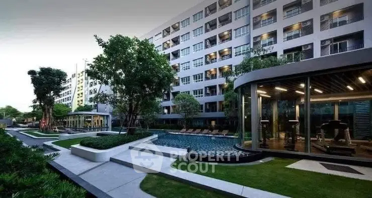 Modern condominium with pool and gym facilities in lush green setting.
