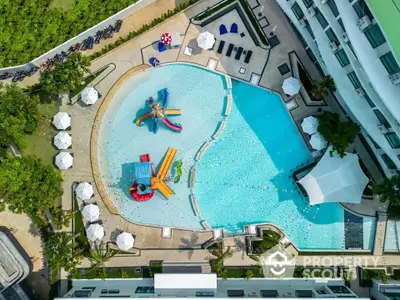 Luxurious aerial view of modern apartment complex with stunning pool and lush greenery