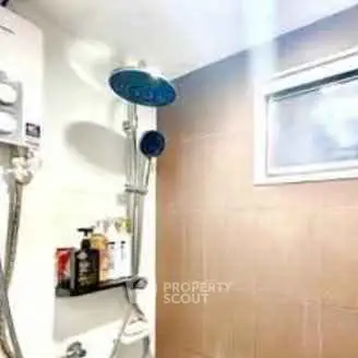 Modern bathroom with shower and small window, featuring sleek design and bright lighting.