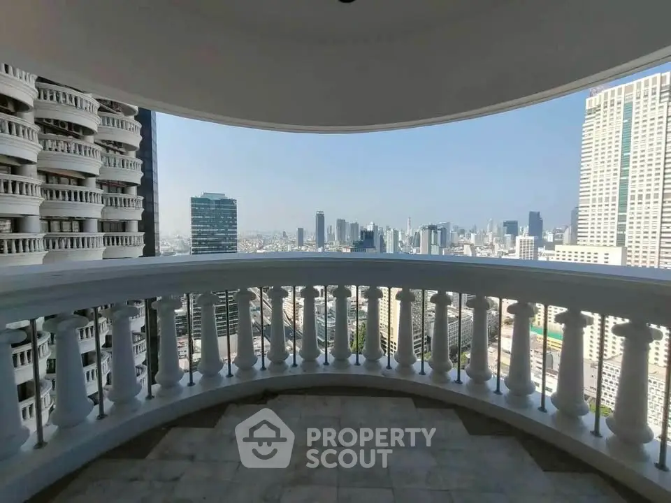 Stunning cityscape view from a spacious balcony in a high-rise building, perfect for urban living.