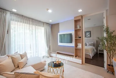 Modern living room with cozy sofa and stylish decor leading to a bedroom