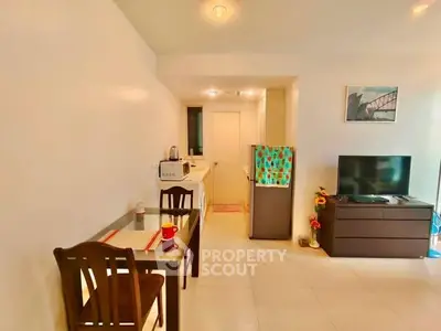 Cozy living room with dining area and modern appliances, perfect for urban living.