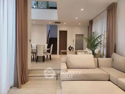 Spacious modern living room with elegant dining area and neutral decor
