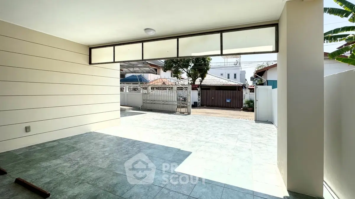 Spacious covered parking area with modern design and ample natural light.