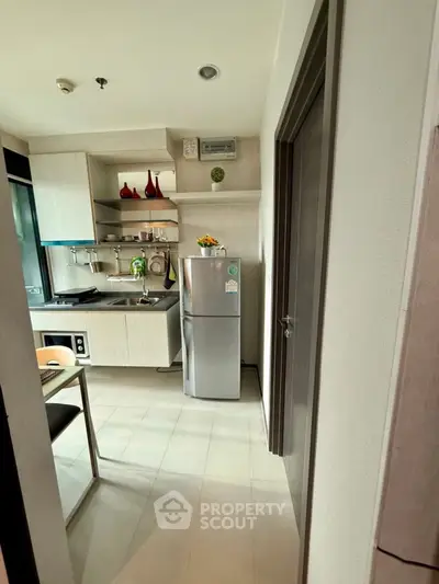 Modern compact kitchen with sleek appliances and stylish decor