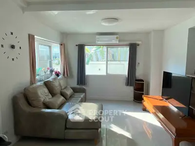 Spacious living room with modern decor and natural light