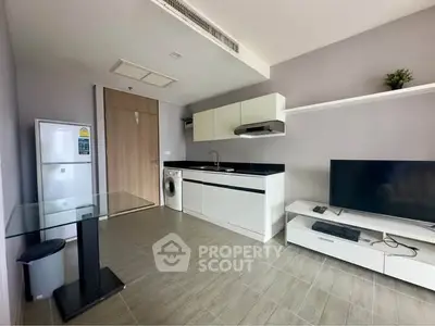 Modern open-layout kitchen with sleek appliances and minimalist design.