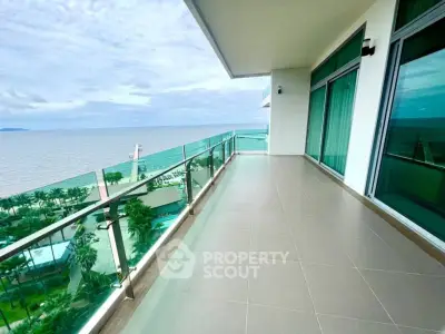 Spacious balcony with stunning ocean view in luxury high-rise apartment.