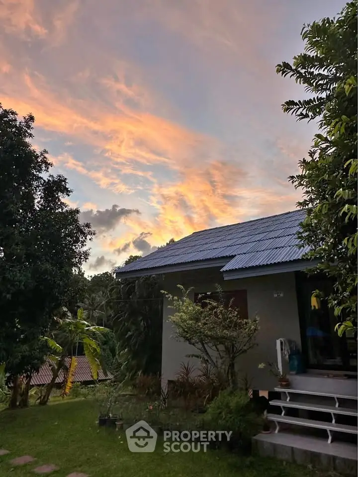 Charming countryside home with lush garden and stunning sunset view, perfect for serene living.