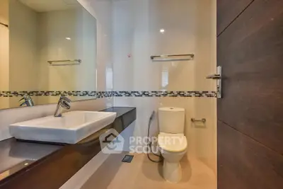 Modern bathroom with sleek fixtures and elegant design, featuring a stylish sink and toilet.
