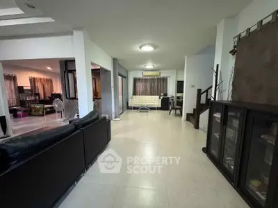 Spacious living room with modern furniture and open layout, ideal for family gatherings.