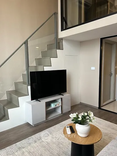 Modern duplex living room with sleek staircase and stylish decor