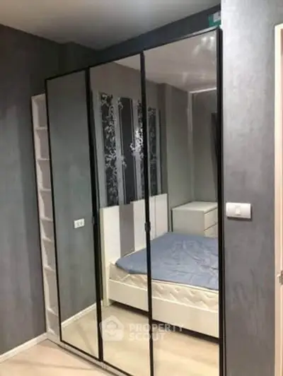 Modern bedroom with mirrored wardrobe and stylish decor