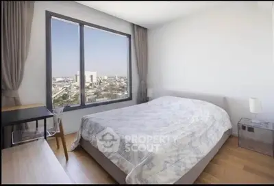 Modern bedroom with city view, featuring a cozy bed and stylish decor.