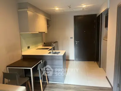 Modern compact kitchen with dining area in stylish apartment