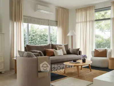 Elegant living room with modern furniture and large windows overlooking greenery.