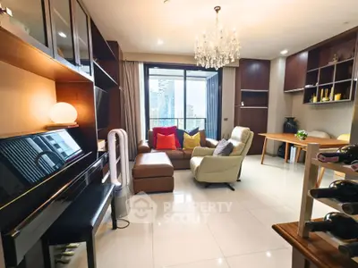 Luxurious living room with city view, elegant chandelier, and modern furnishings.