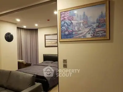 Cozy bedroom with elegant decor and modern lighting, featuring a comfortable bed and stylish artwork.