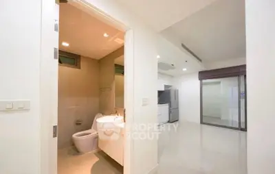 Modern apartment interior with sleek bathroom and spacious kitchen area