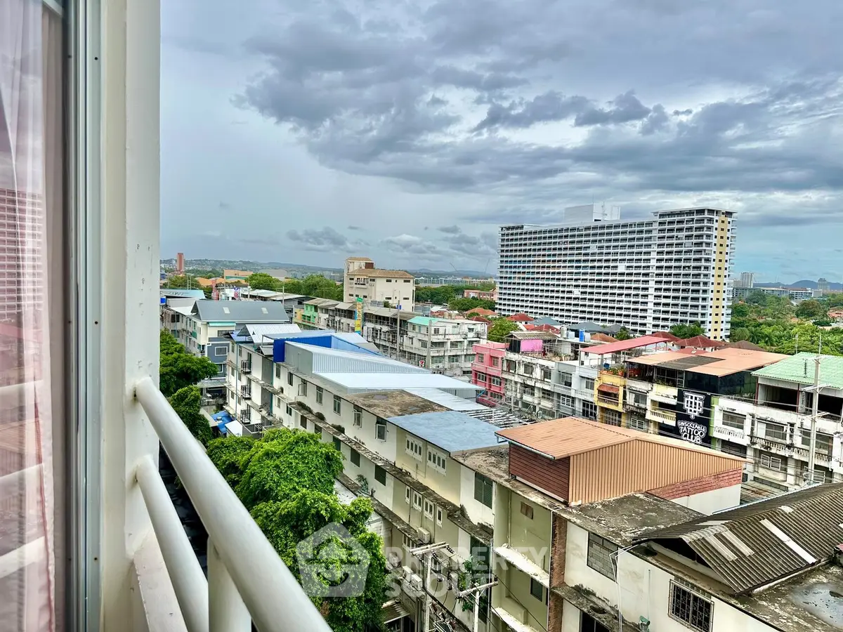 Stunning cityscape view from a high-rise balcony showcasing urban architecture and skyline.