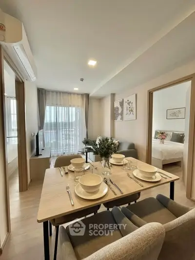 Modern open-plan living and dining area with elegant decor and natural light